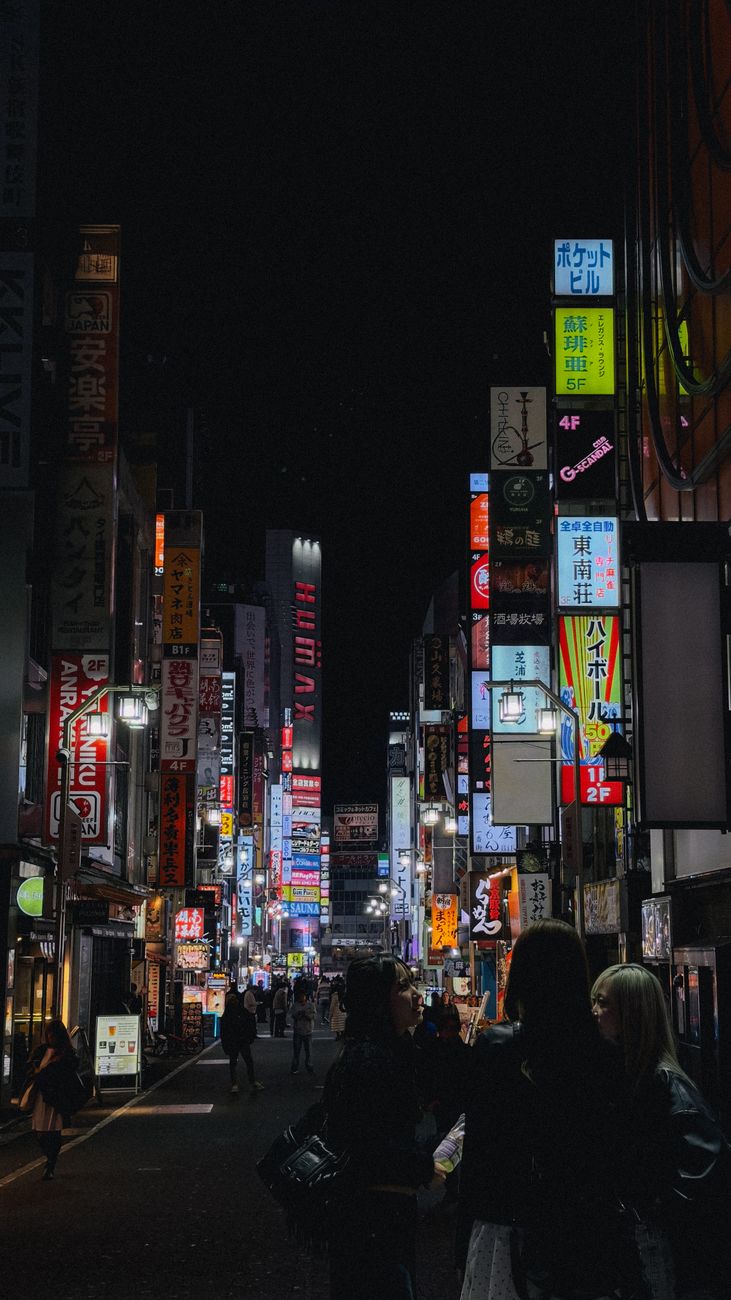 Experience Tokyo's vibrant nightlife with bustling streets full of neon lights and diverse crowds.