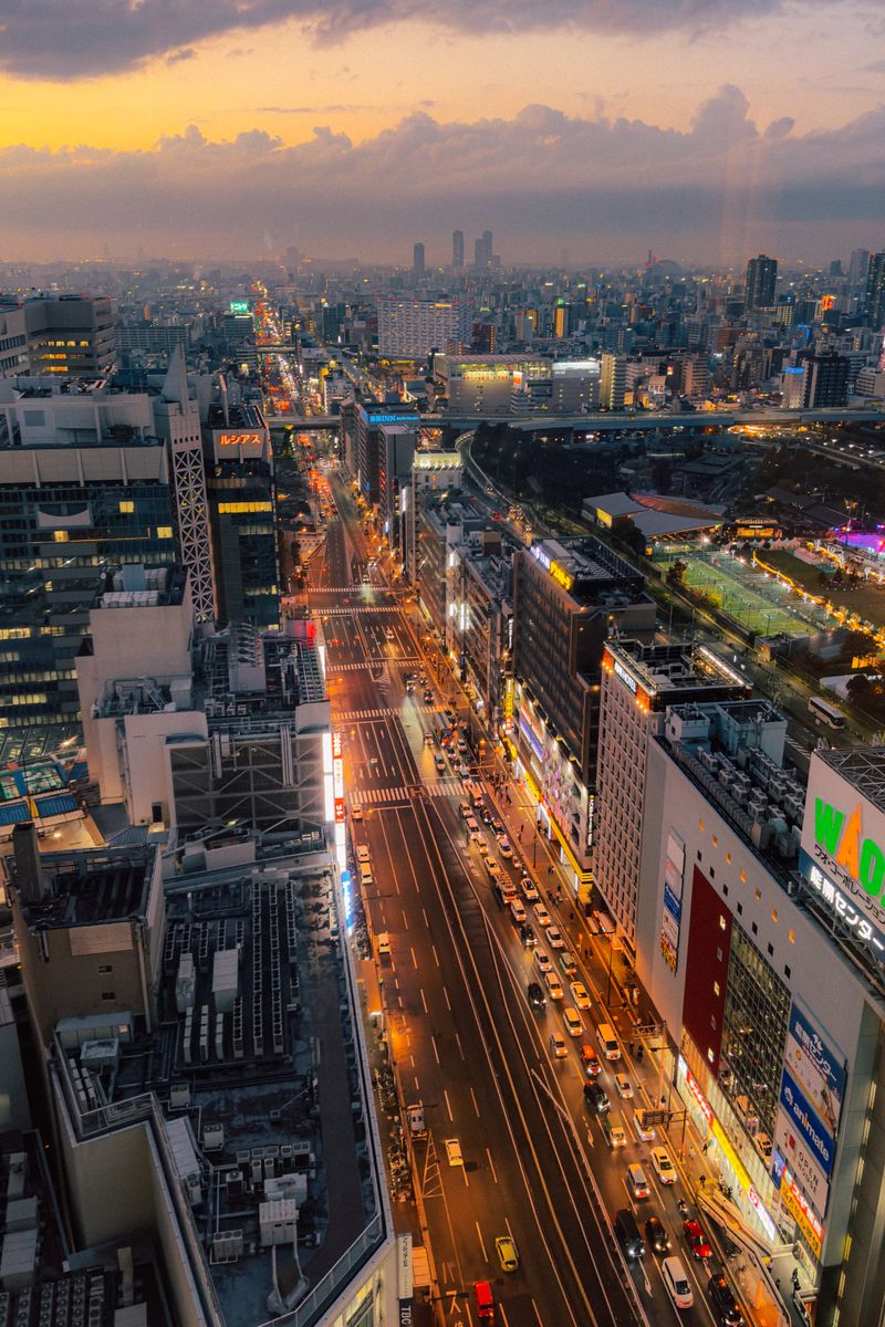 Aerial view of Tokyo's bustling streets and city lights at dusk, showcasing the city's vibrant urban landscape.