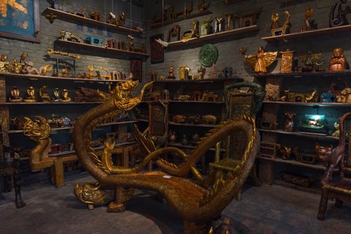 Free Explore a collection of traditional Vietnamese handicrafts in a Hanoi shop filled with intricate golden sculptures. Stock Photo