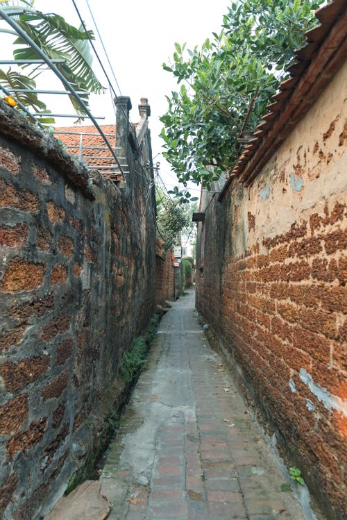 Free Explore a traditional narrow alleyway in Hanoi, Vietnam, showcasing local architecture. Stock Photo
