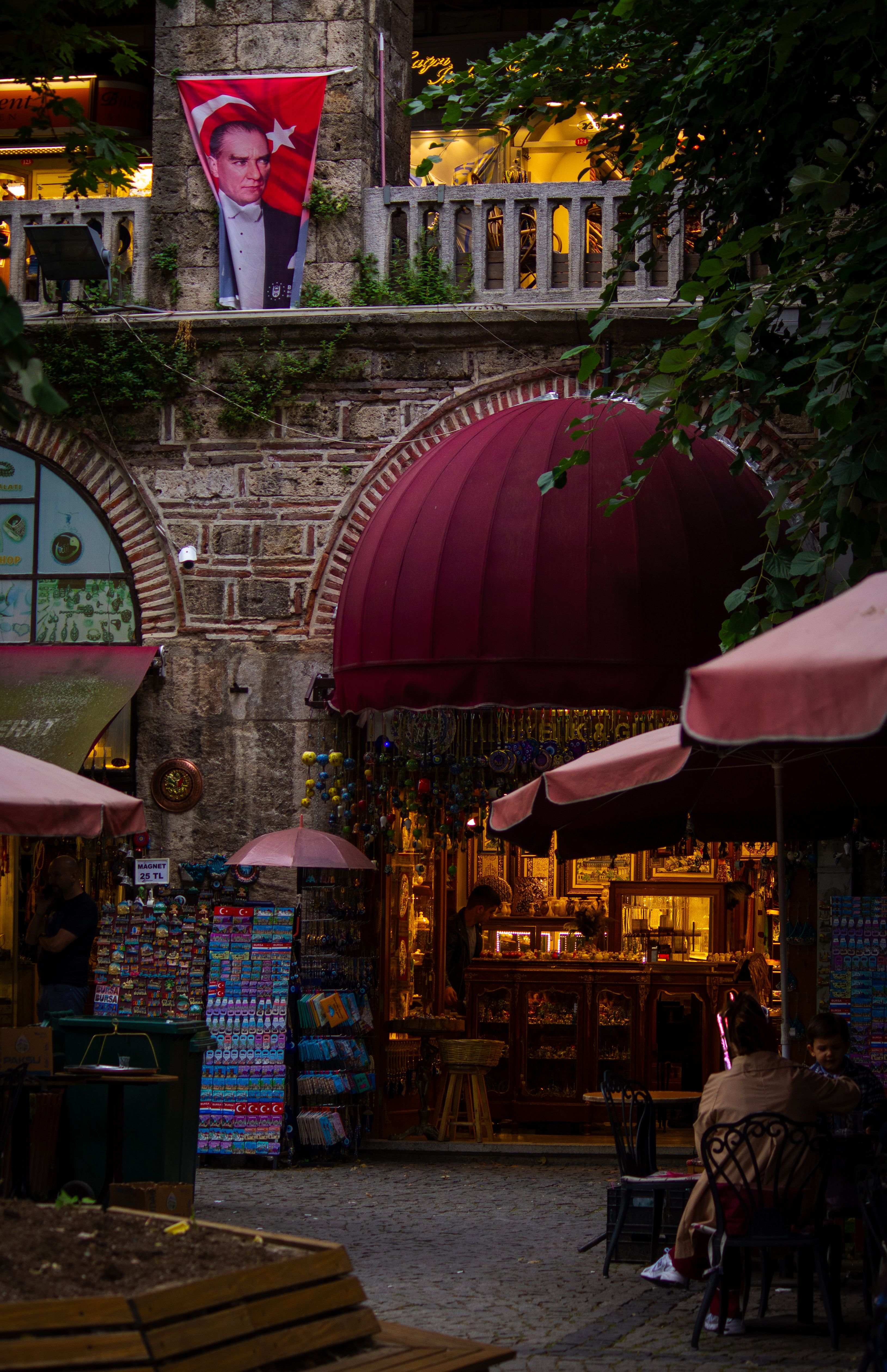 Explore the vibrant and historic atmosphere of Koza Han in Bursa, Türkiye, captured under evening lights.