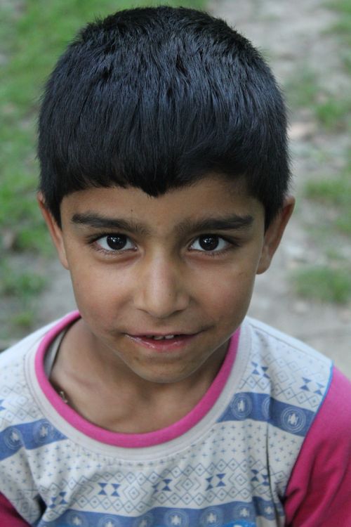 Portrait of a Smiling Young Boy Outdoors · Free Stock Photo