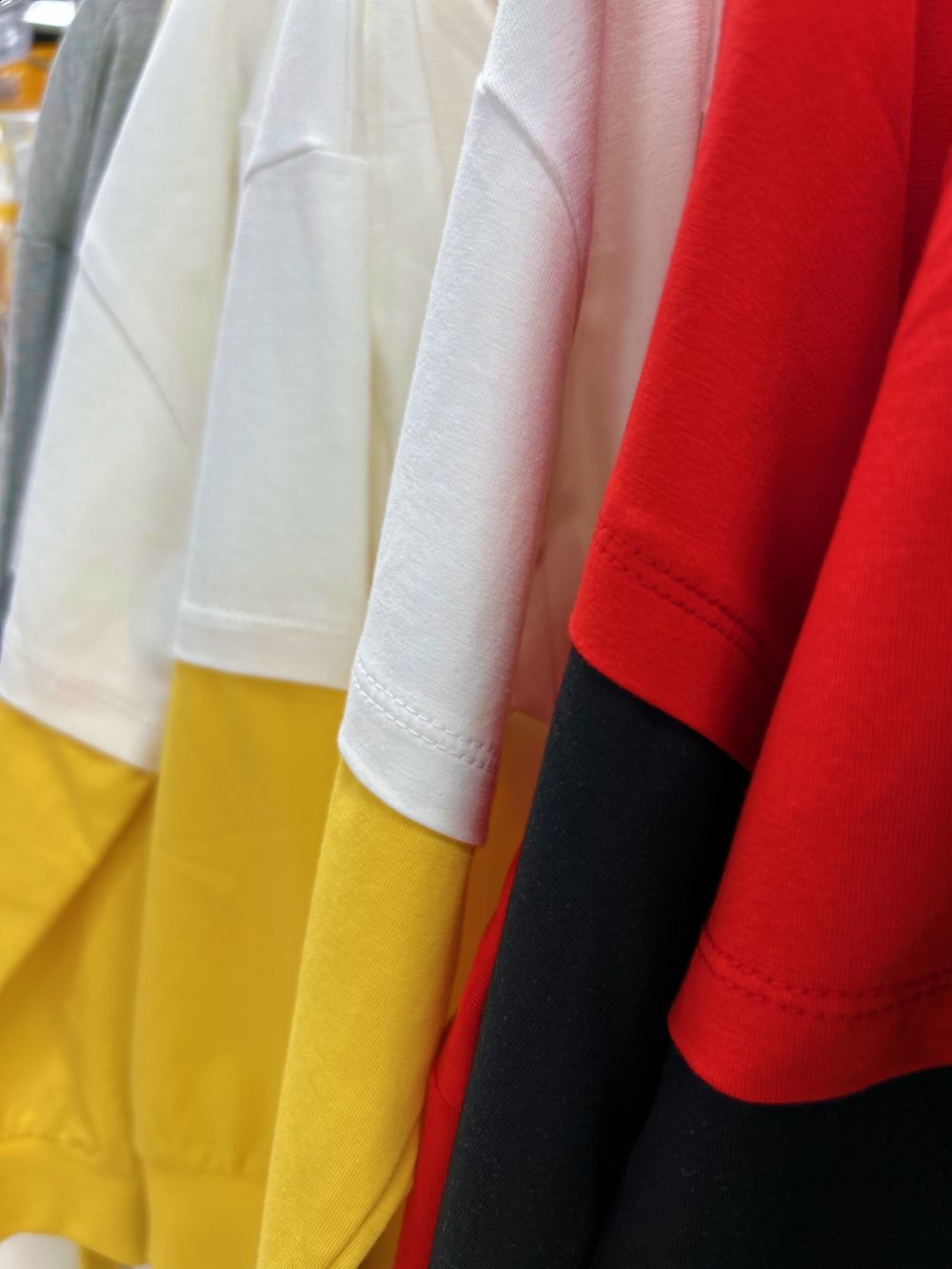 Close-up of folded colourful cotton t-shirts
