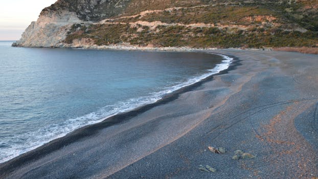 A serene view of the coastal landscape at Ogliastro Beach, Corsica, France, during the daytime.