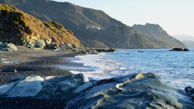 Beautiful coastal landscape of Ogliastro, Corse with rocky beach and rugged mountains.