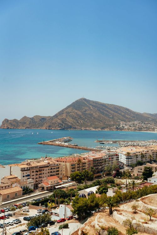 Free A breathtaking aerial view of Altea, Spain with mountains and a vibrant coastline under a clear blue sky. Stock Photo