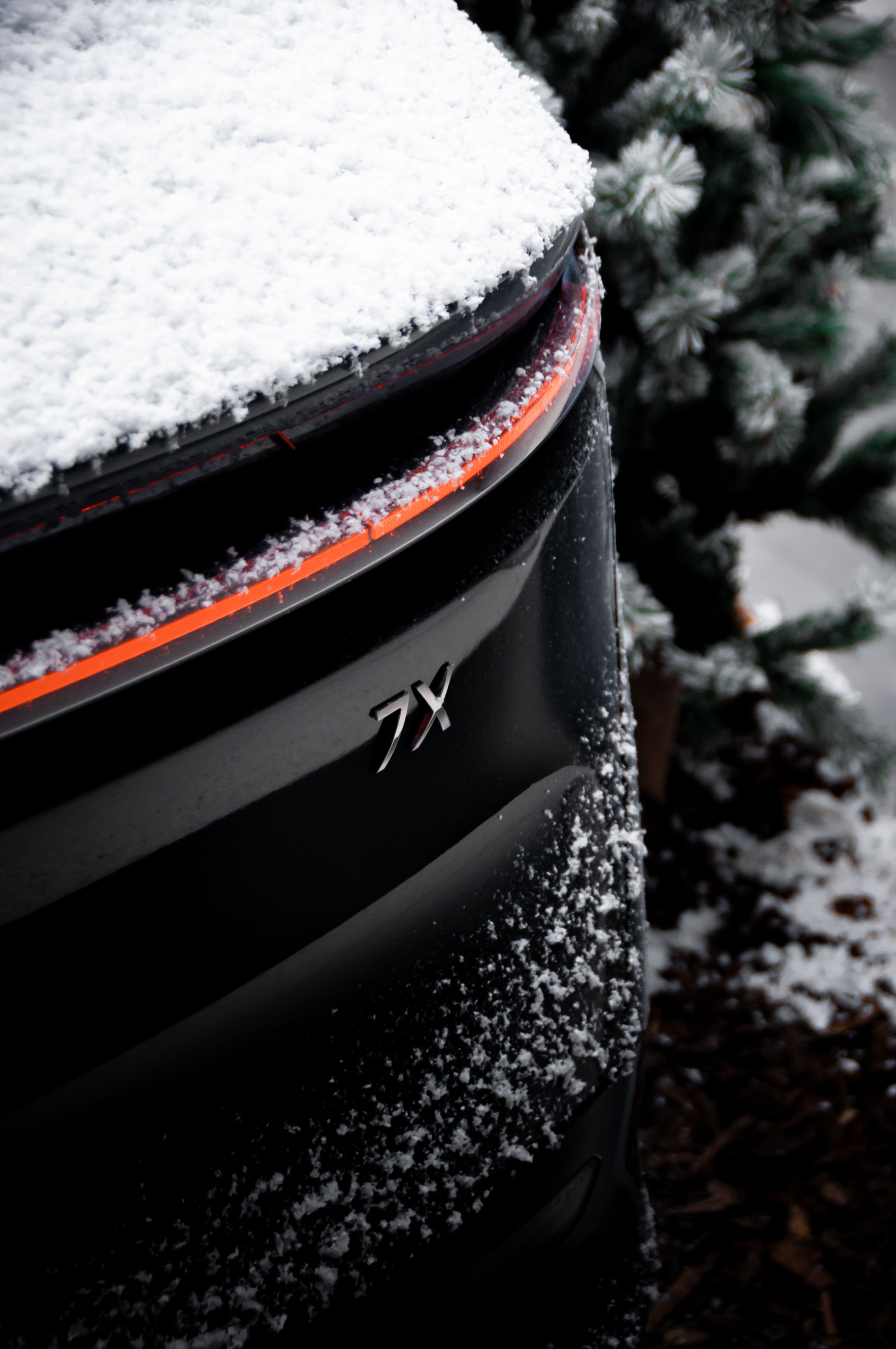 Snow-covered black electric car parked outdoors in winter — EV cold weather range comparison 2026