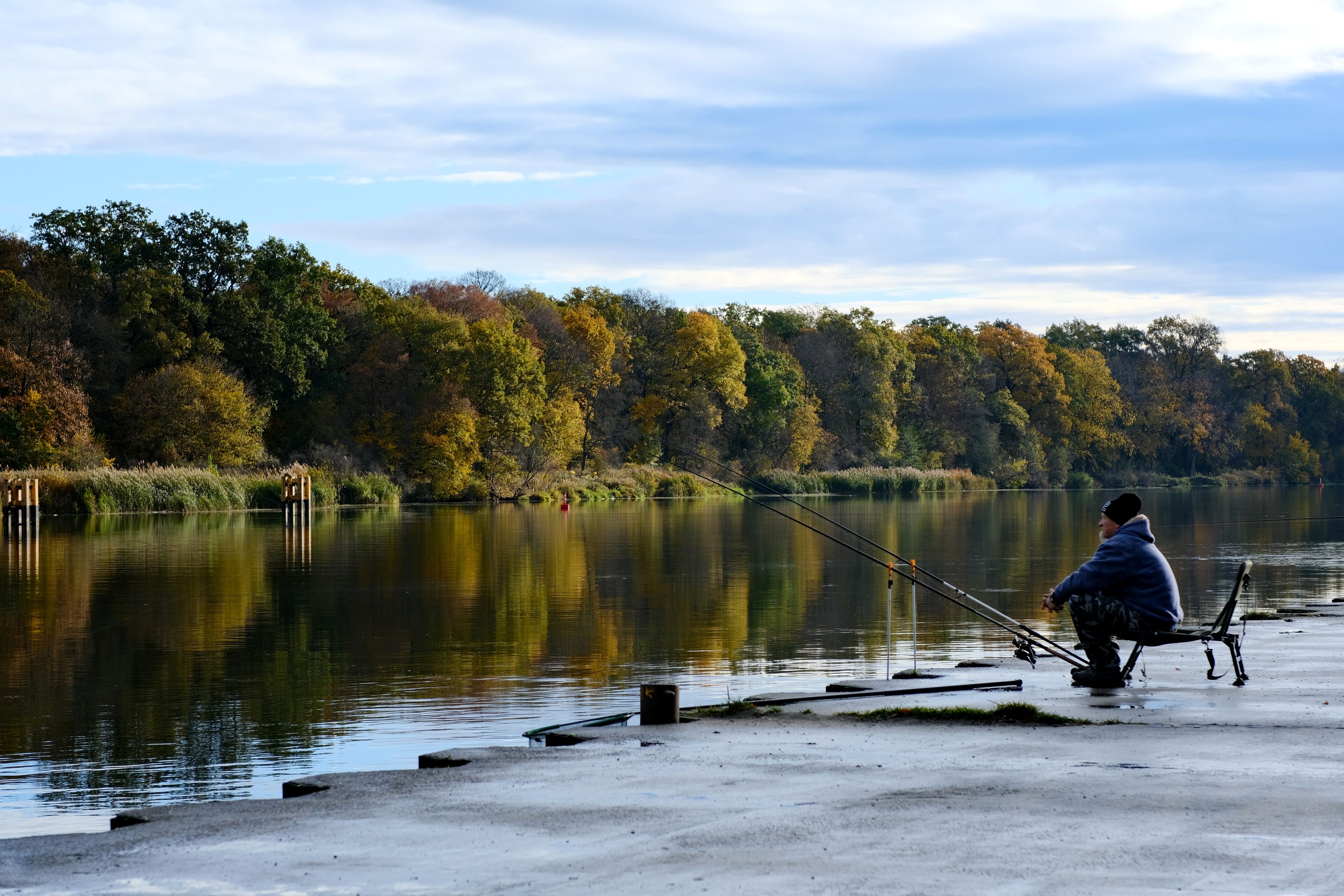 Peaceful Autumn Fishing by a Tranquil River · Free Stock Photo