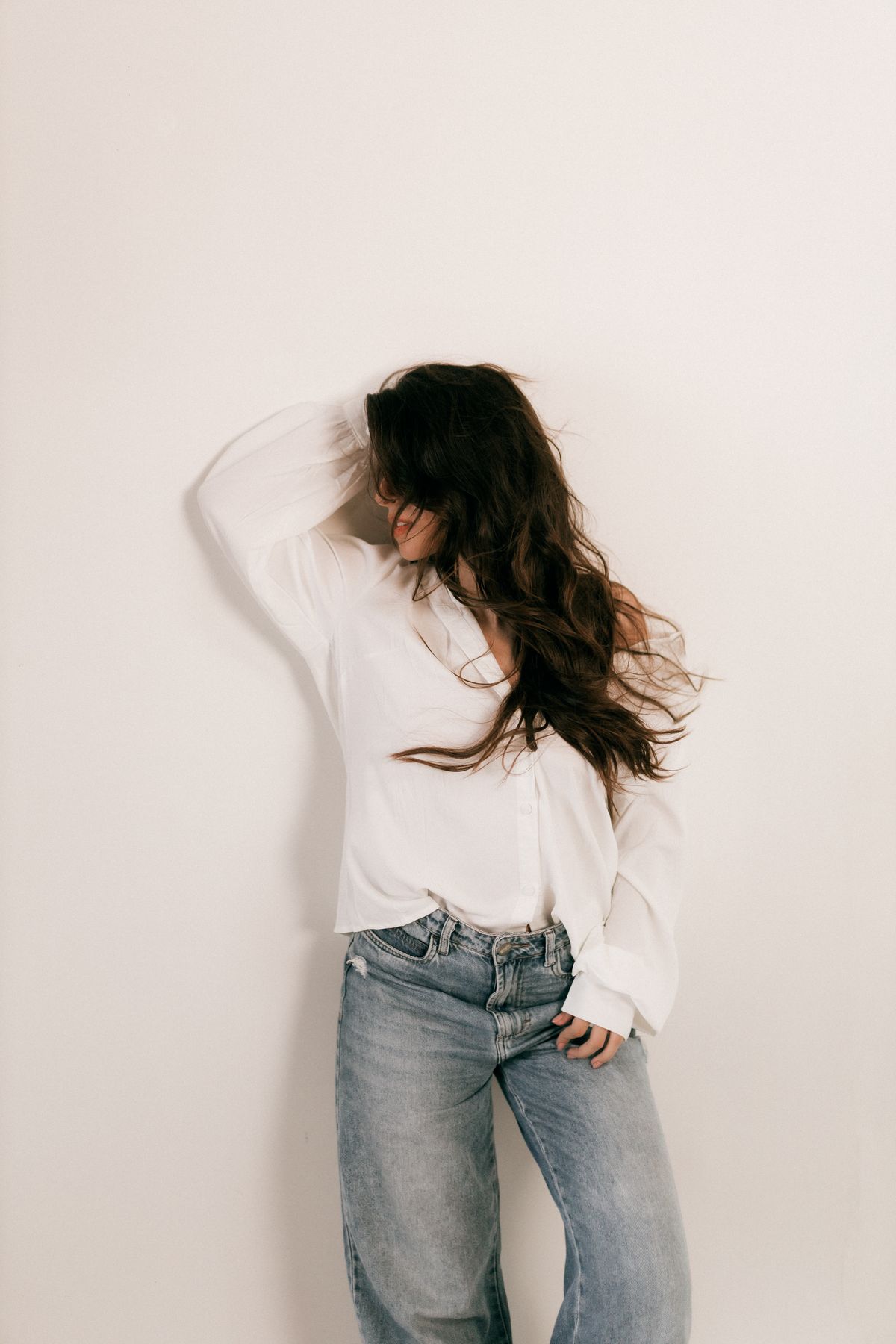 A woman in a white shirt and jeans — the considered denim wardrobe