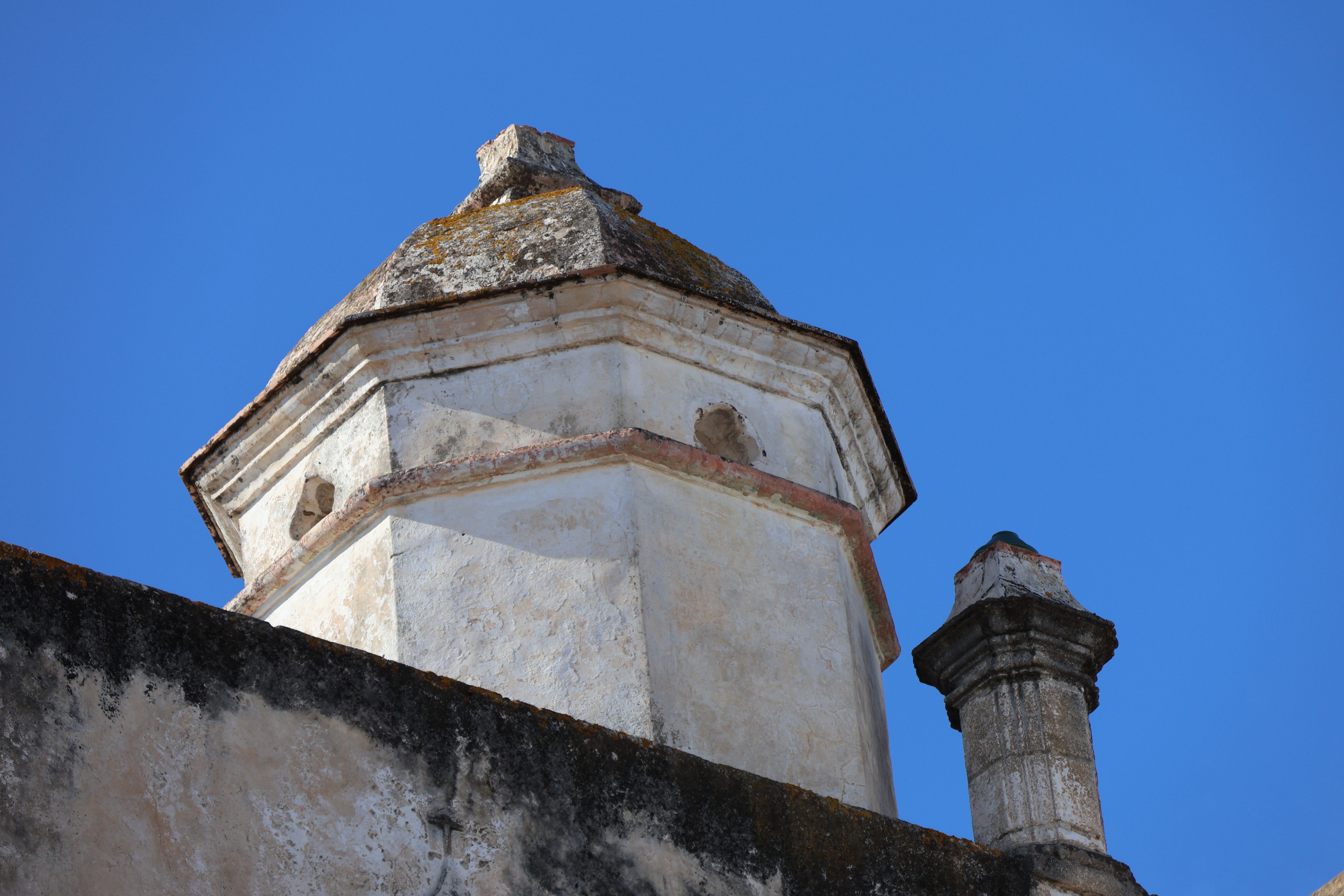 The iconic stone tower ruins of Panama Viejo archaeological site against a blue sky