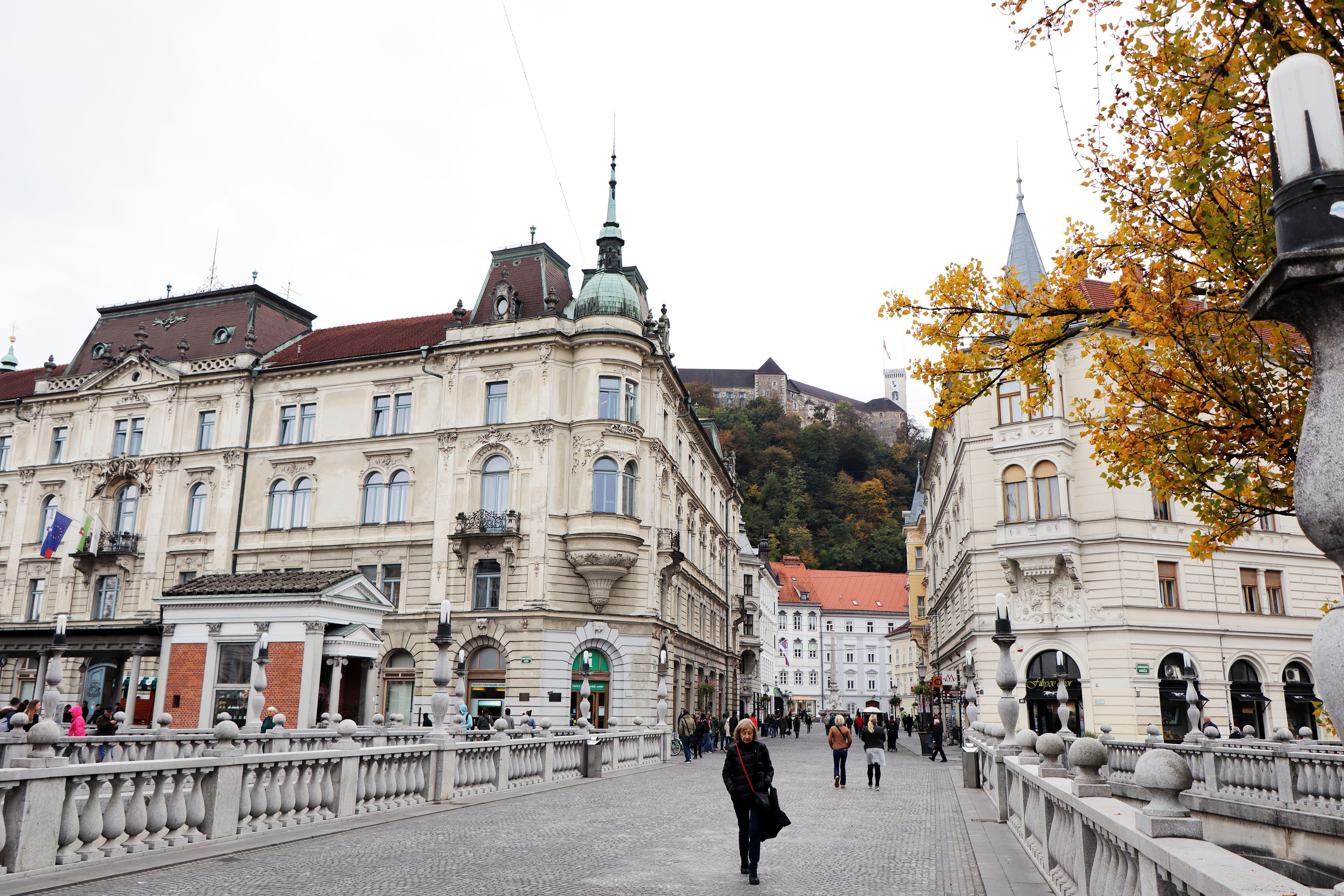 Beautiful autumn day in Ljubljana featuring historical architecture and vibrant fall foliage.