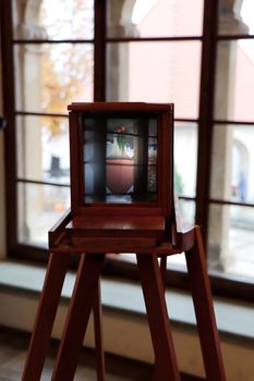 Old camera on display in Radovljica, Slovenia museum with window view.