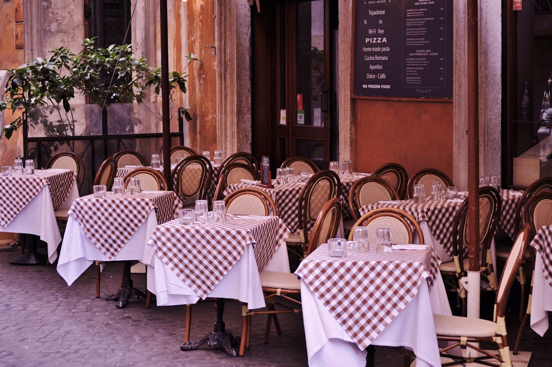 Free Empty Tables and Chairs in Restaurant by the Street Stock Photo