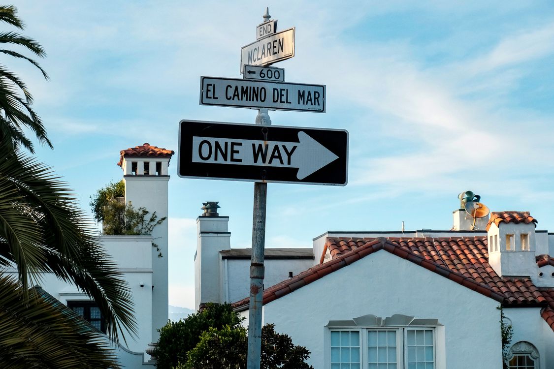 Local Spanish Sign Street signs near Spanish-style architecture in California · Free Stock ...