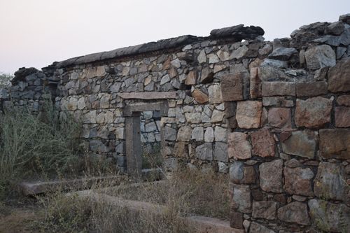 Free Aged stone wall remnants of a historical building set against an outdoor landscape. Stock Photo