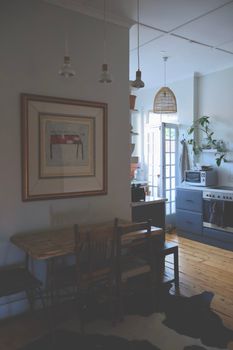Warm and inviting rustic kitchen featuring wooden accents, artwork, and soft lighting.