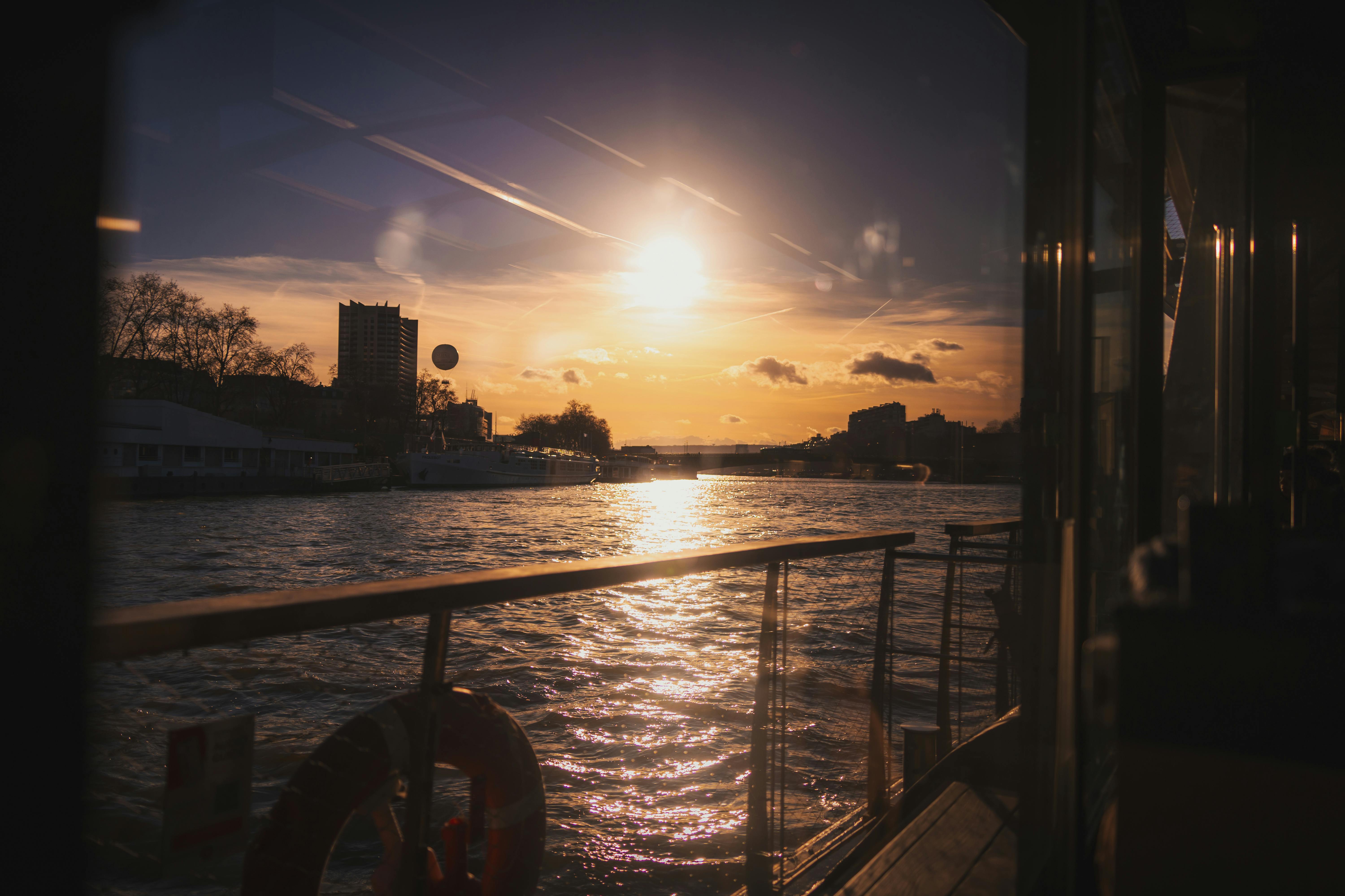 A picturesque sunset over the River Seine viewed from a boat in Paris, France.