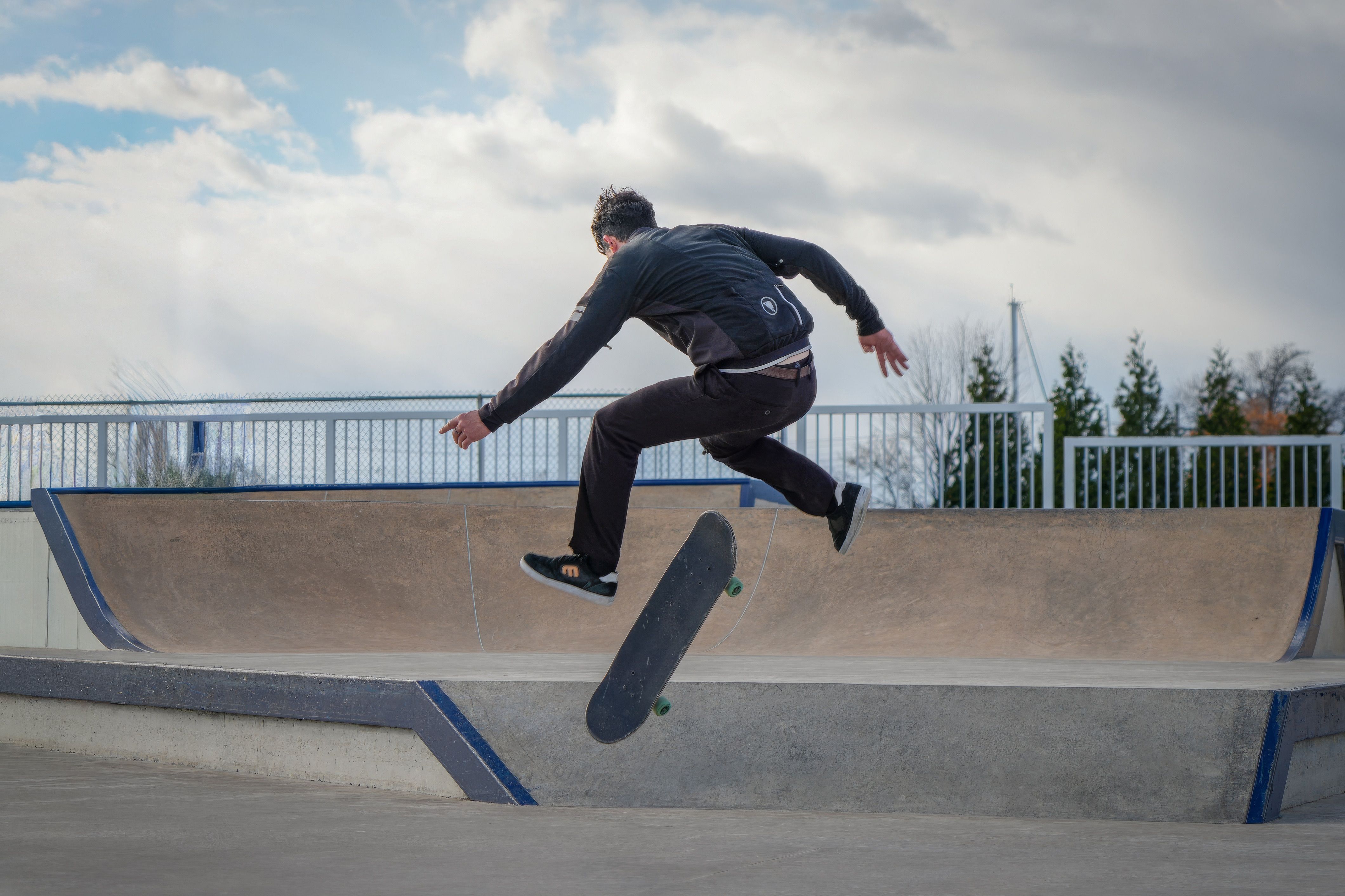 Action shot of a skateboarder performing a trick in an outdoor skatepark.