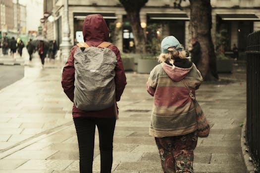 Moody urban street scene with pedestrians walking after a rainstorm.