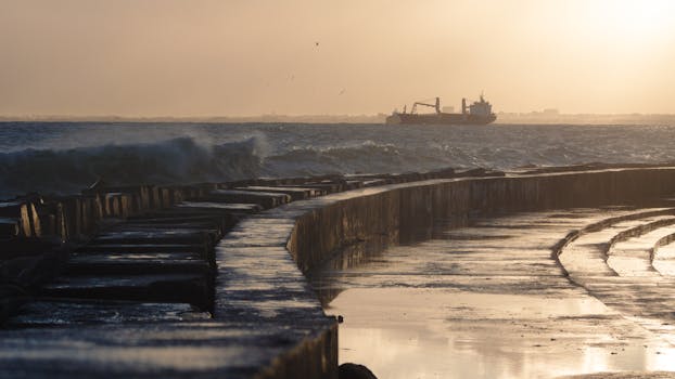 Freighter ship sailing in the ocean at sunrise, captured with HDR effect for cinematic look.