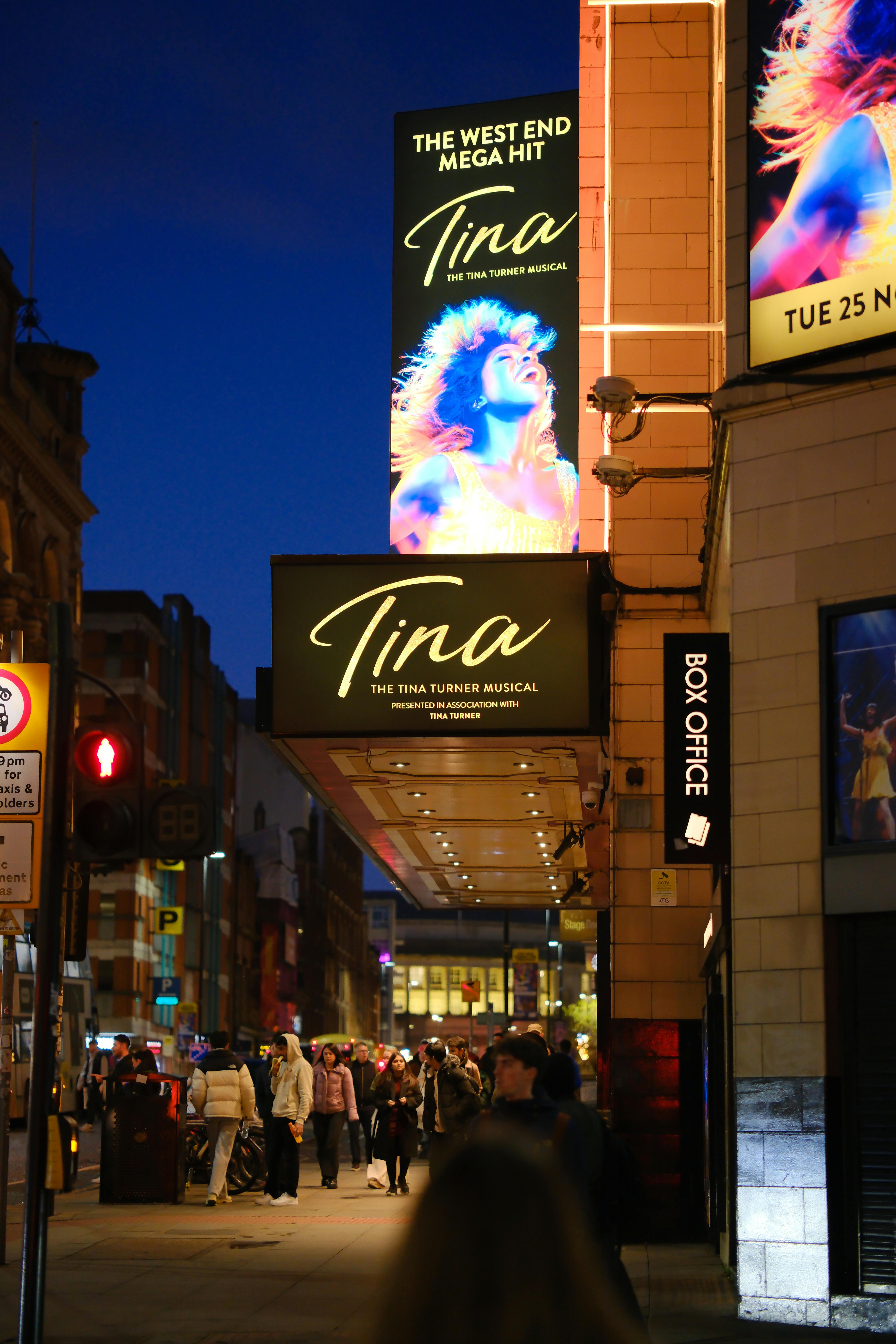 Free Crowd gathers outside Tina Turner Musical theater in London's vibrant West End at night. Stock Photo