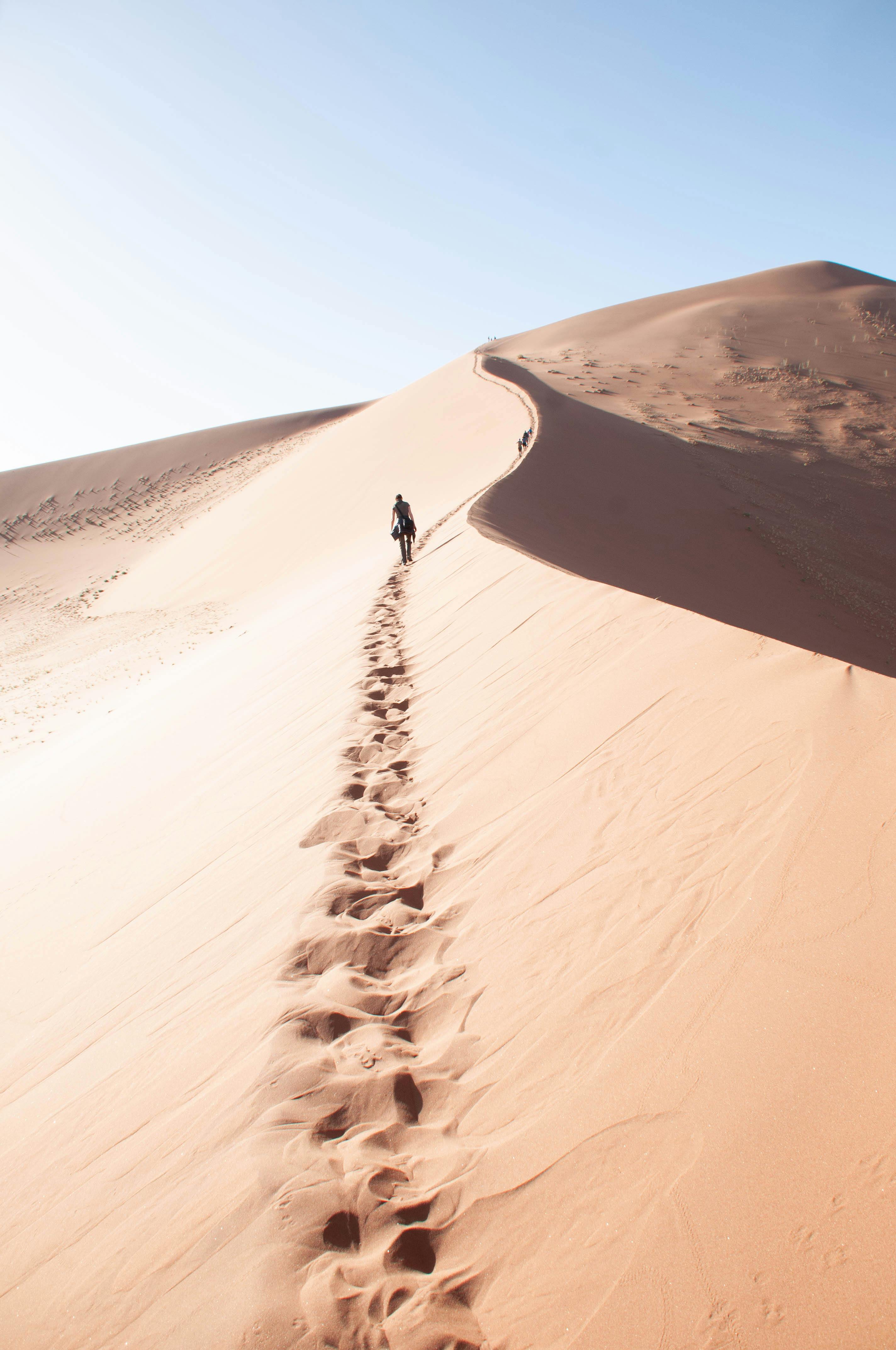 Person Walking on Sand · Free Stock Photo