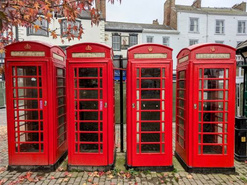 Free A row of iconic red British phone boxes in Ripon, England, UK. Perfect for travel and history themes. Stock Photo