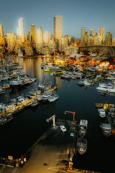 A breathtaking view of yachts and cityscape at twilight in Vancouver's marina.