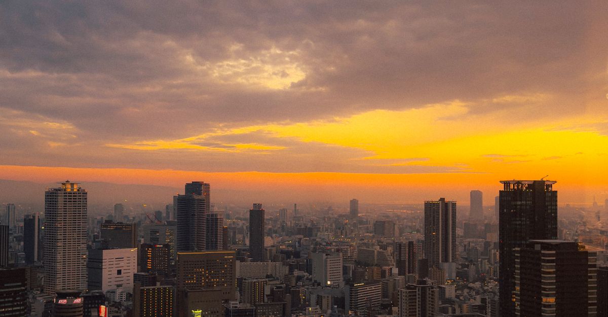 Breathtaking view of Osaka, Japan's skyline under a vibrant sunset.