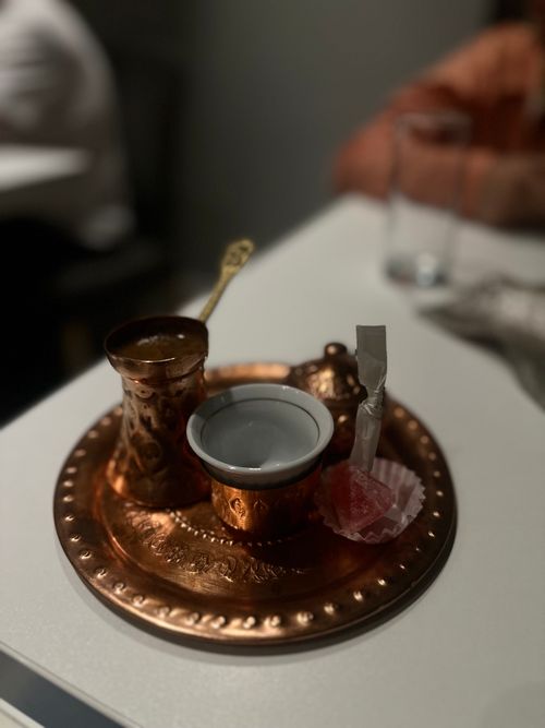 Free Authentic Bosnian coffee served in a copper set with Turkish delight on a table. Stock Photo