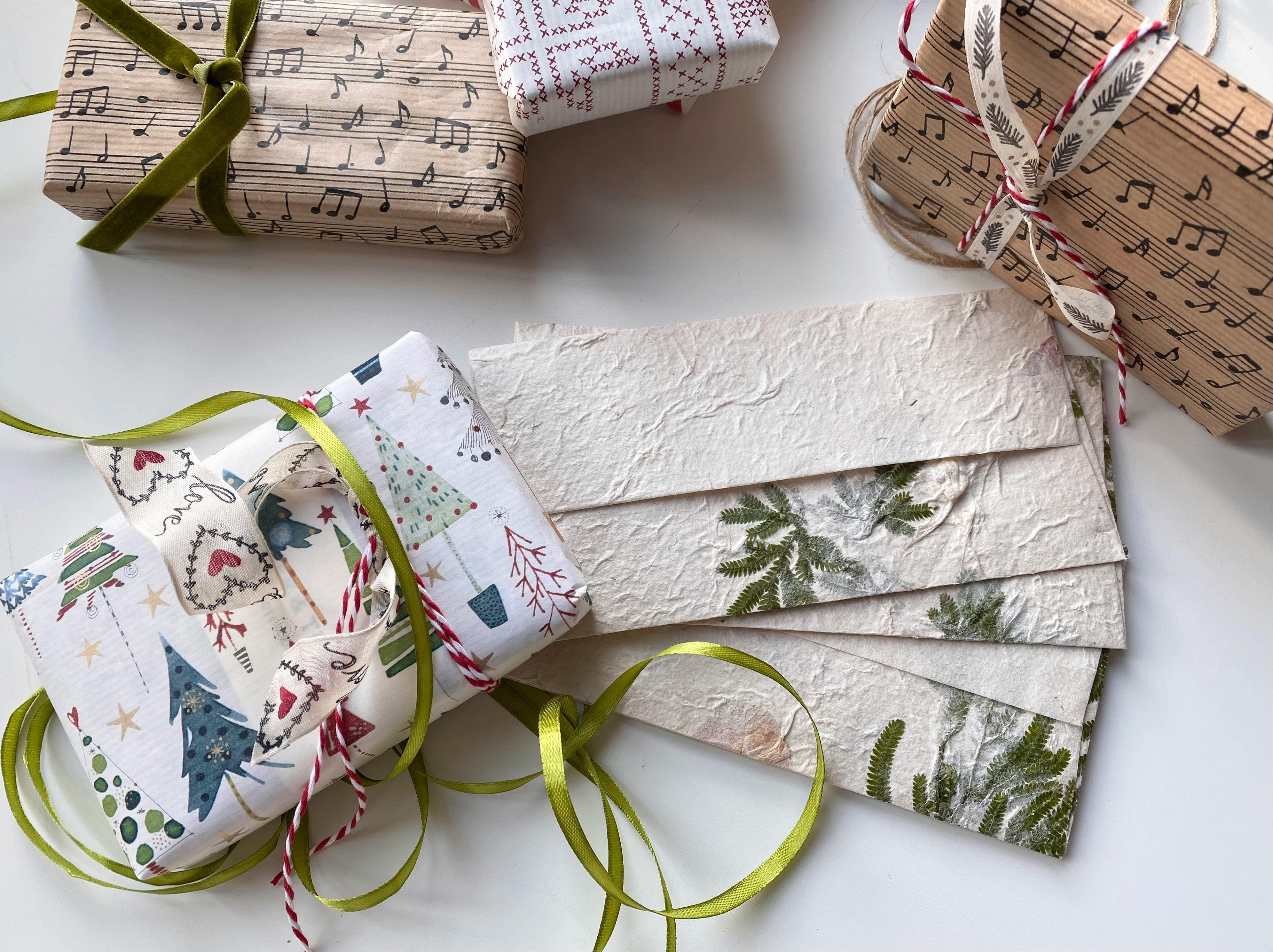 Beautifully wrapped holiday gifts with nature and music-themed designs, perfect for Christmas.