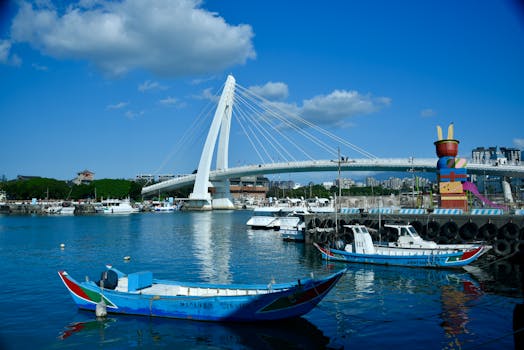 A vibrant view of Fisherman's Wharf with boats and the Lover's Bridge under a clear blue sky.