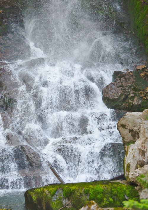 Free Majestic waterfall in lush forest, Switzerland, perfect for nature enthusiasts and travel guides. Stock Photo