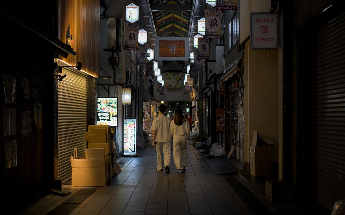 Nishiki Market at night in Kyoto — the covered market street with its food stalls and vendors