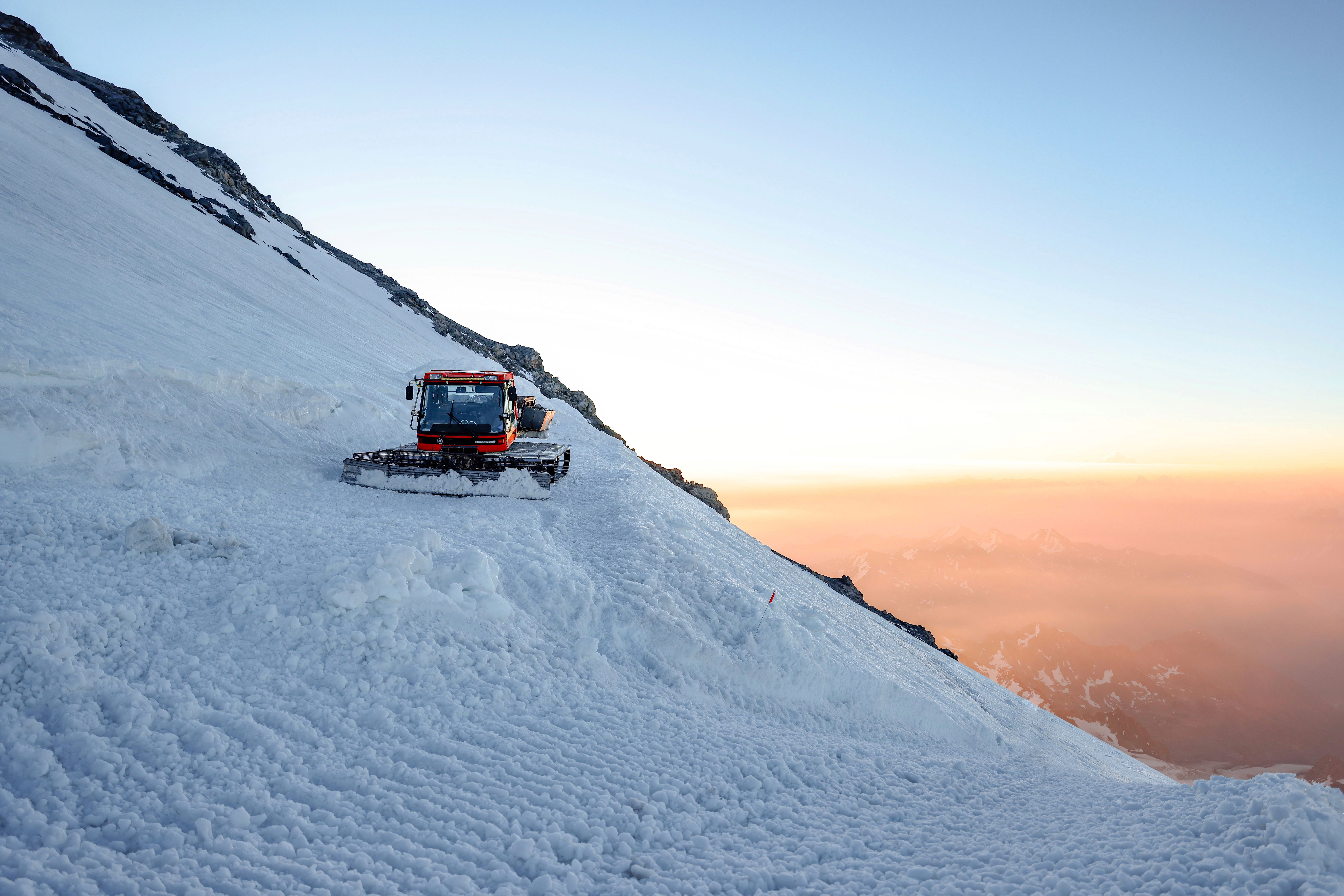 Snow Groomer on Alpine Mountain at Sunset · Free Stock Photo