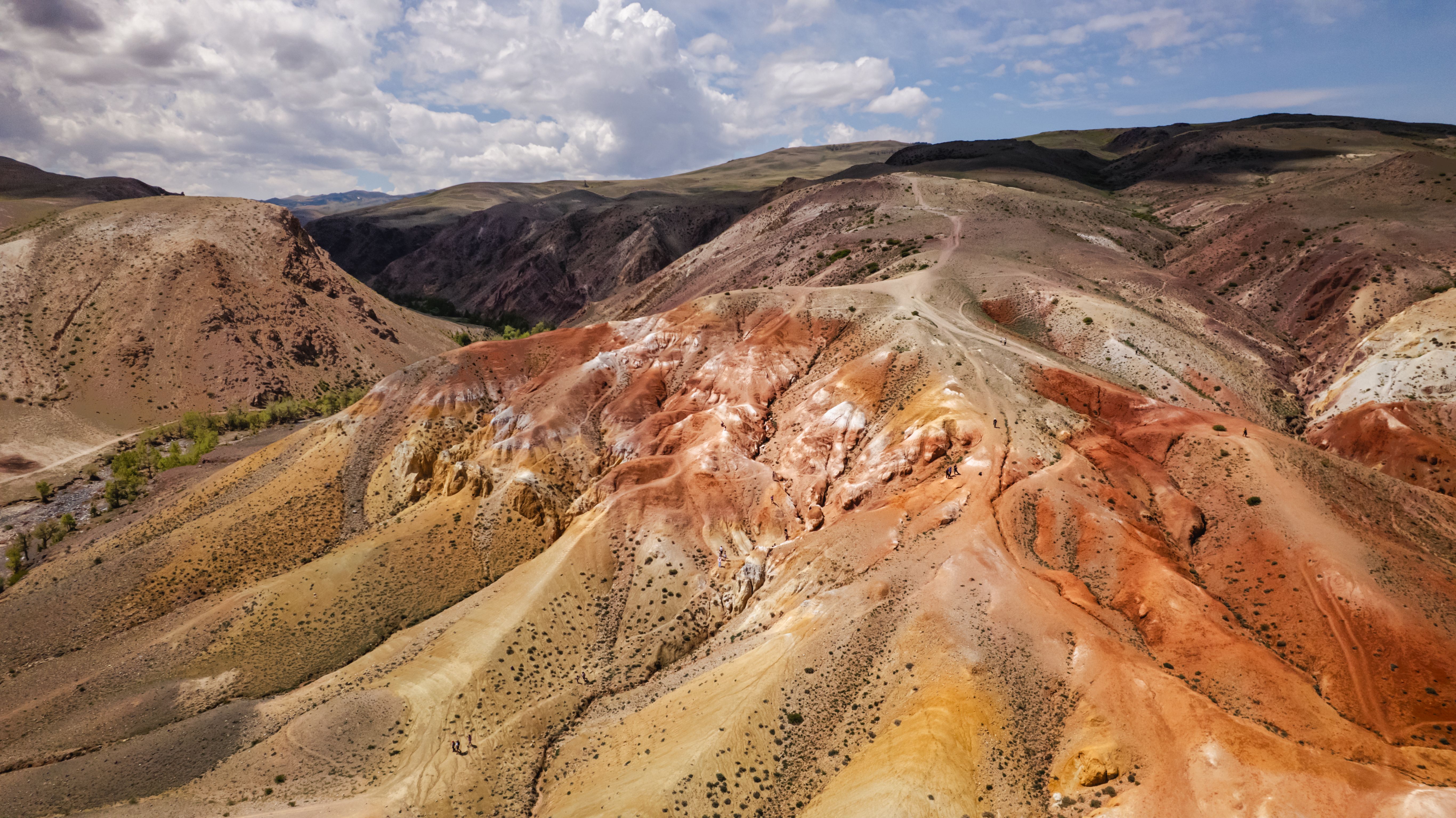 Stunning aerial shot of red and orange mountains resembling a Martian landscape.