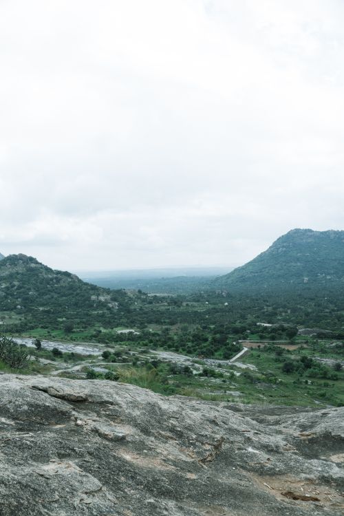 Free Tranquil hillside view near Bengaluru, showcasing lush green landscapes and rocky terrains. Stock Photo