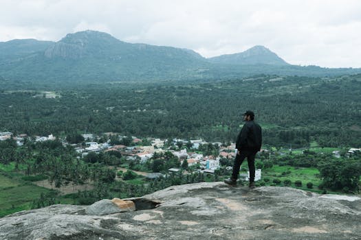 Explore breathtaking views of Bengaluru's lush countryside from a hilltop perch, perfect for adventure and relaxation.
