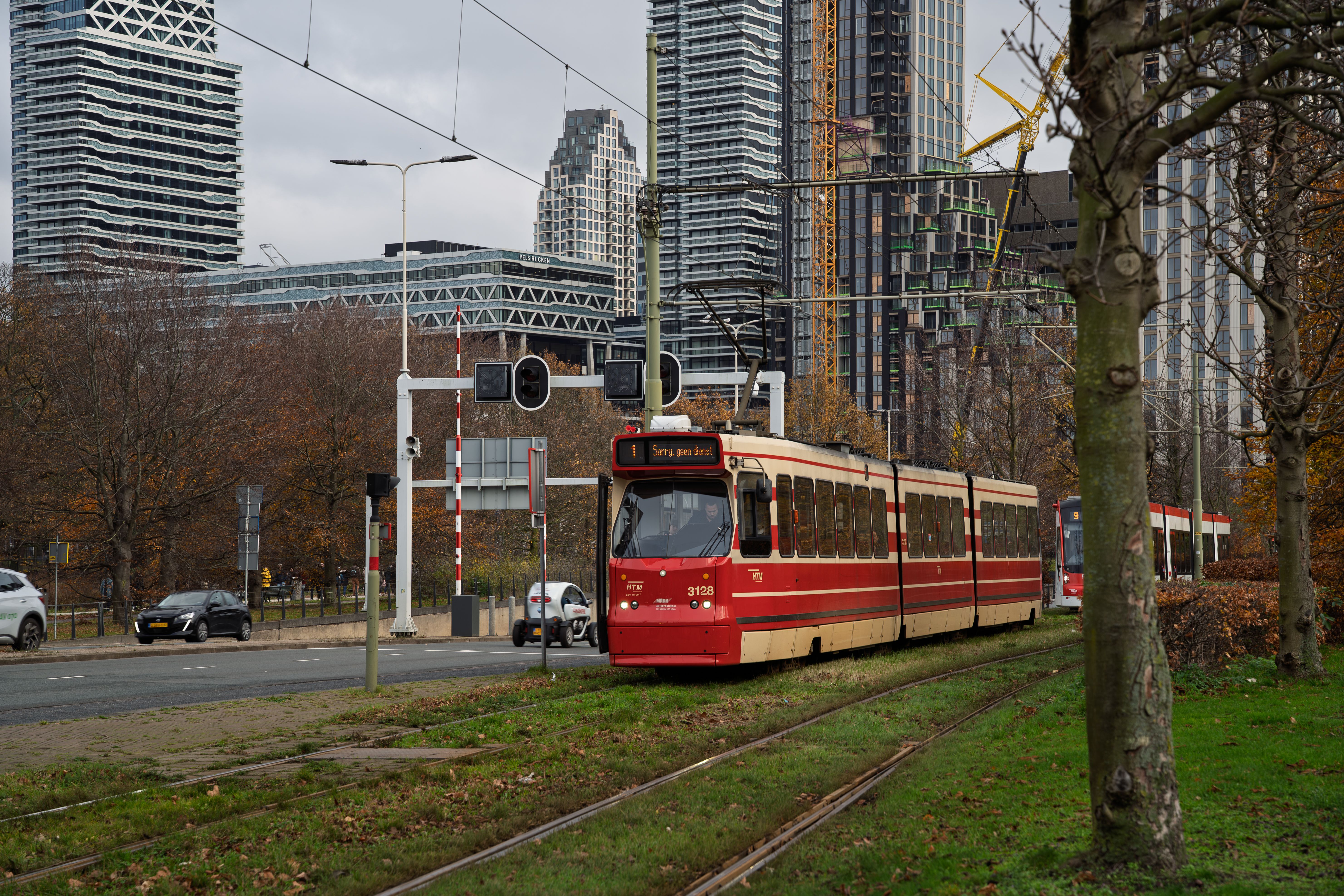 Red tram in urban cityscape with skyscrapers · Free Stock Photo