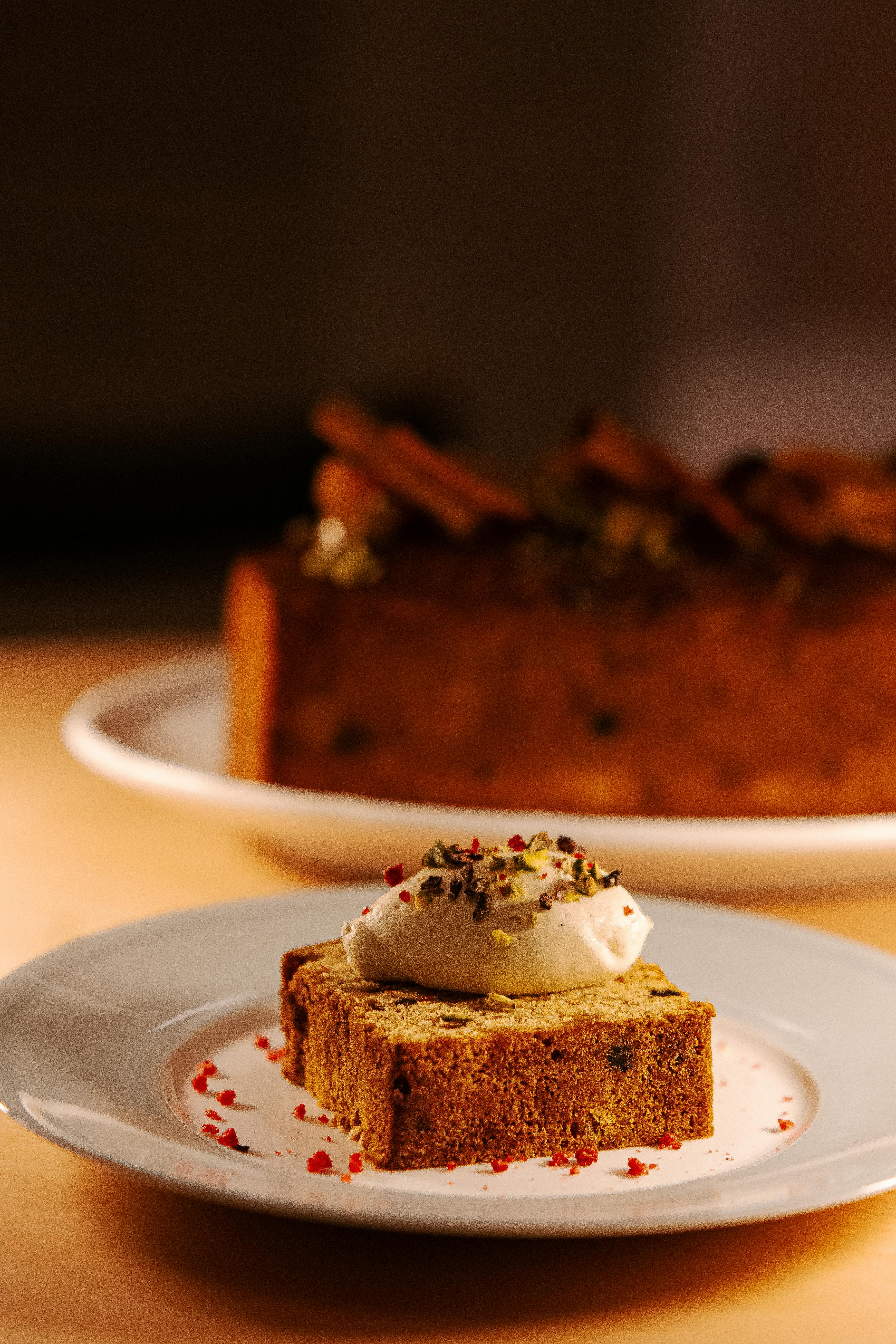 A mouth-watering slice of gourmet cake topped with cream served at a café in Tokyo, Japan.