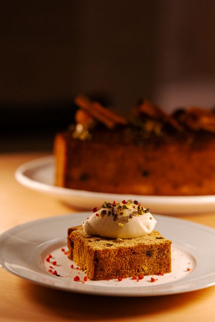 A mouth-watering slice of gourmet cake topped with cream served at a café in Tokyo, Japan.