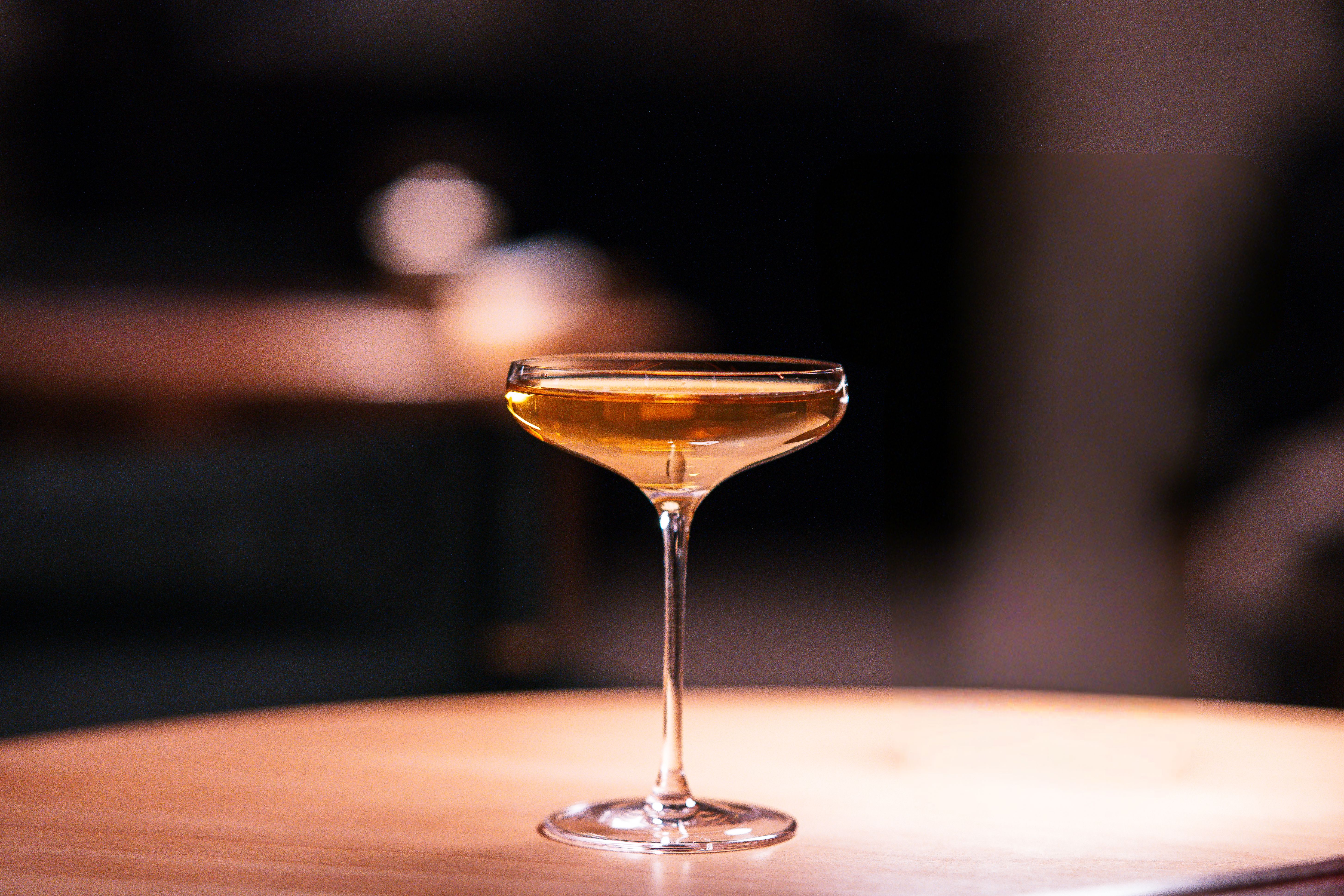 Elegant cocktail glass in a dimly lit bar