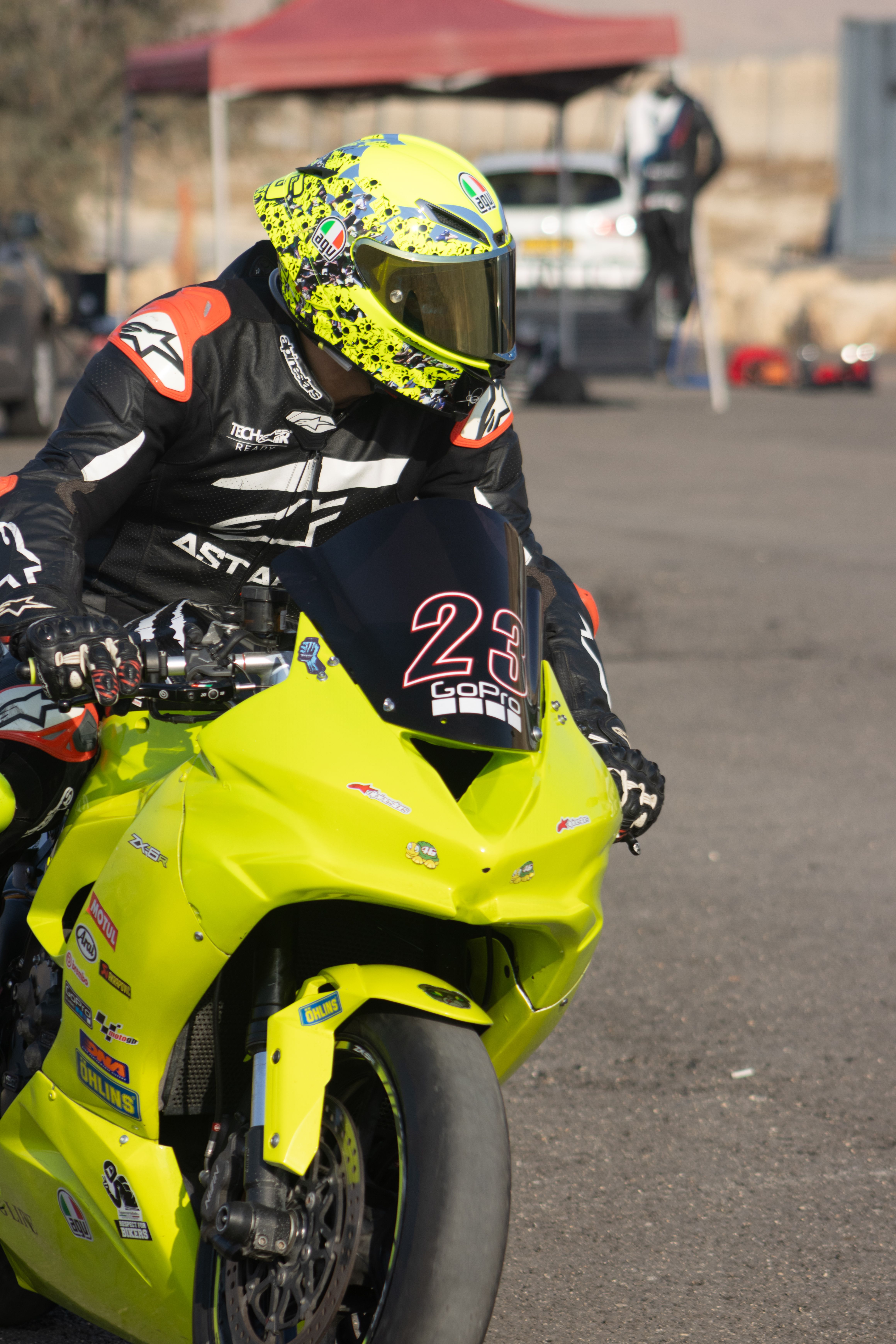 Vibrant Helmeted Motorcycle Racer on Track · Free Stock Photo