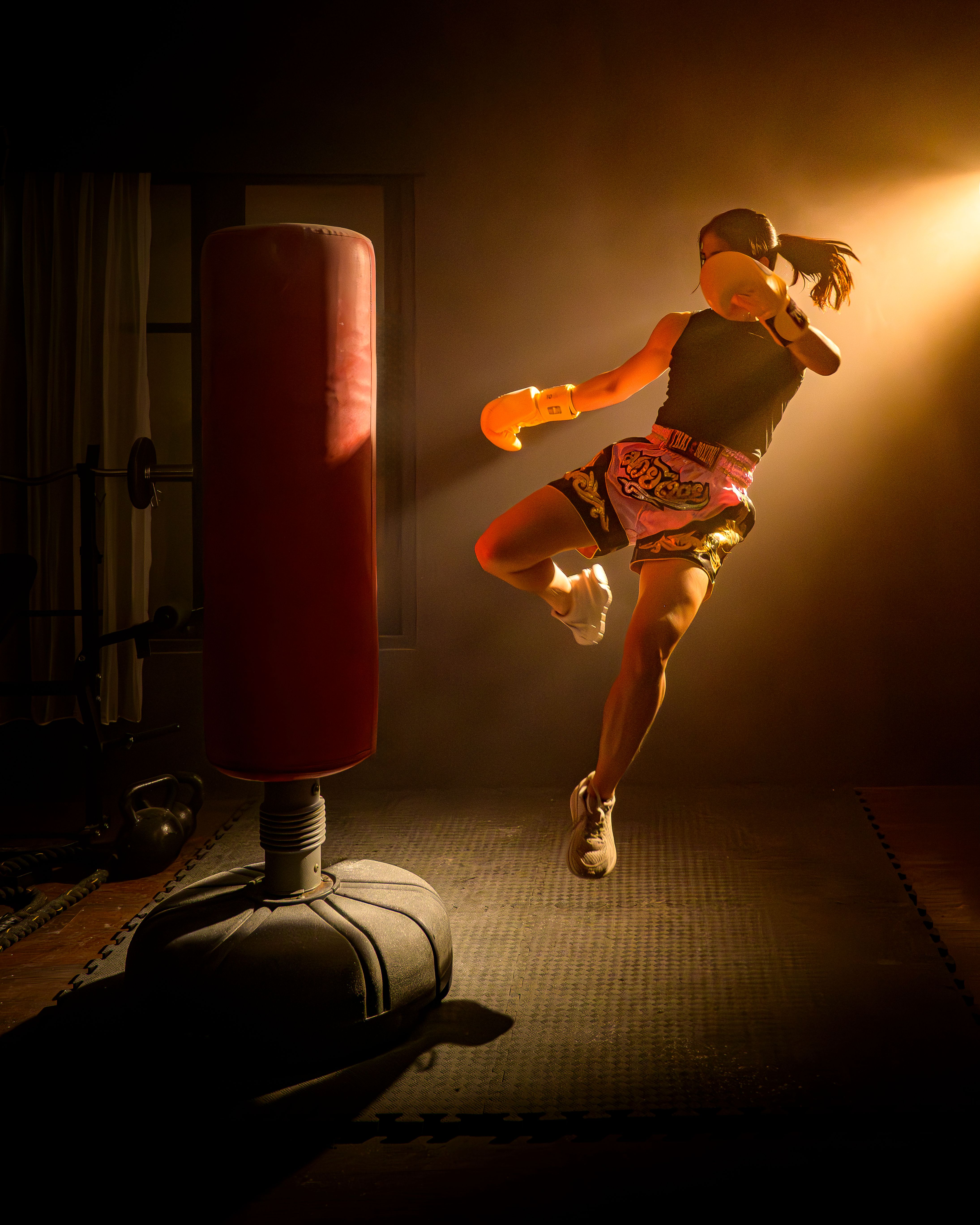 Woman kickboxing at home