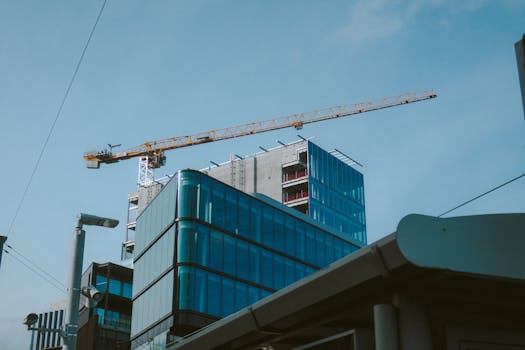 A modern building under construction with a crane in Dublin, Ireland skyline.