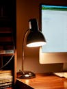 Cozy Workspace with Illuminated Desk Lamp