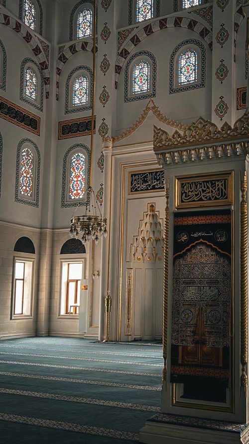 Free A beautifully detailed view of ornate mosque interior with stained glass windows. Stock Photo