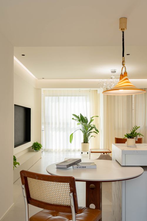 Free Bright, minimalist living room with plants and stylish lighting. Stock Photo