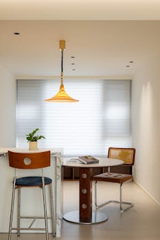 Sleek dining area featuring modern furniture and warm lighting.
