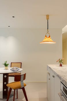 Modern kitchen interior featuring marble and chic decor elements.